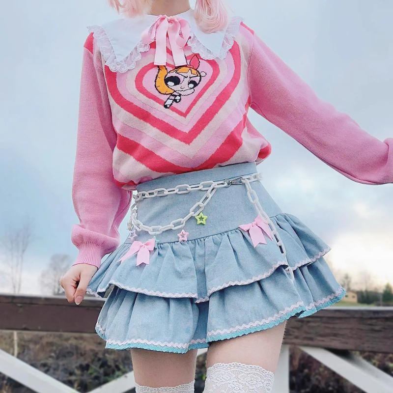 Flat lay of denim skirt with kawaii accessories and pastel tones