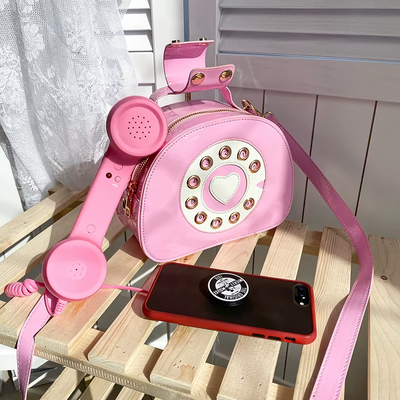 Pink kawaii phone-shaped bag with 3.5mm mobile connection, retro design, waterproof exterior, and a comfortable touch.