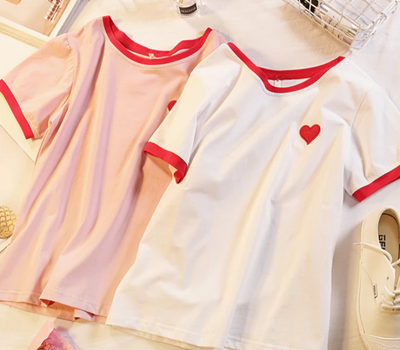 Tee in white with a small red heart, adding a cute and subtle touch to your outfit.