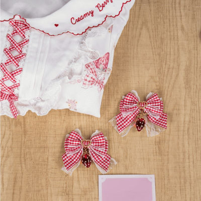 Pair of plaid bowknot hairclips with strawberry charm, kawaii Lolita style.