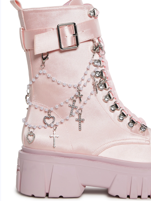 Angelcore Mayhem Boots with chunky platforms, shiny satin build, adjustable ribbon laces, buckle straps, side zippers, and removable beaded straps with cross and heart charms.