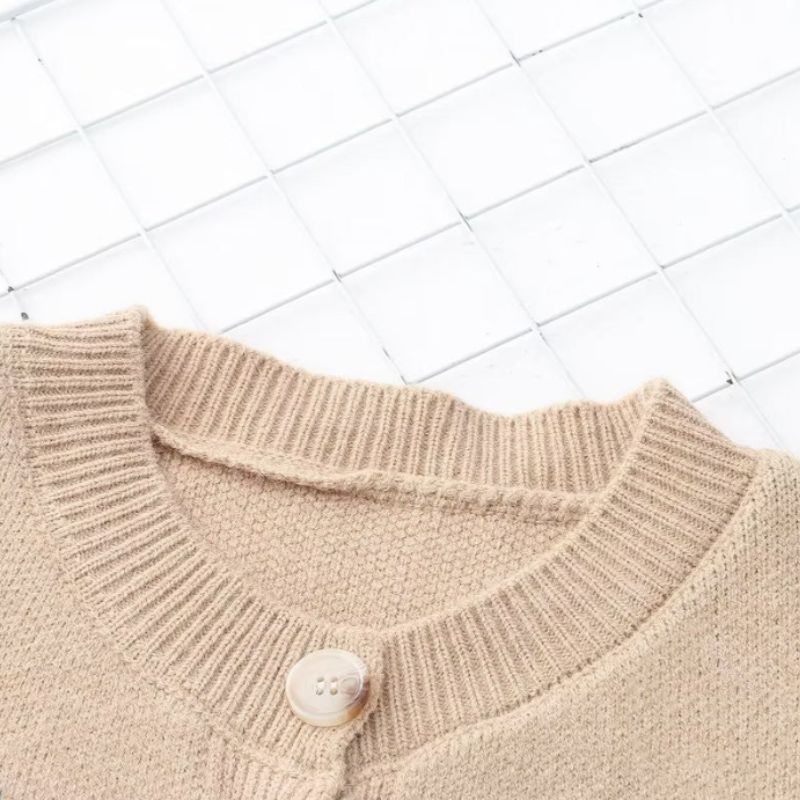 Cartoon knit cardigan with round neckline, playful designs and front pockets.
