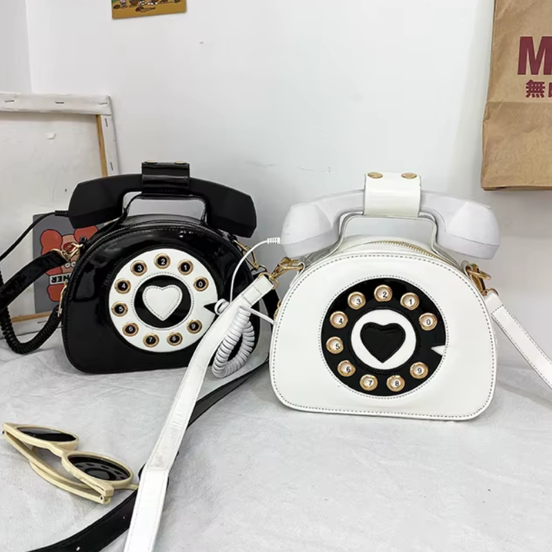 Overview of the kawaii phone-shaped bags in black and white, highlighting the retro design, contrasting details, and 3.5mm mobile connection.