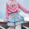 Flat lay of denim skirt with kawaii accessories and pastel tones