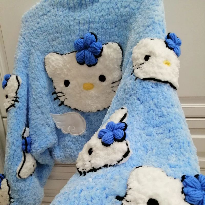 Soft knitted kawaii cardigan in light blue with kitty accents