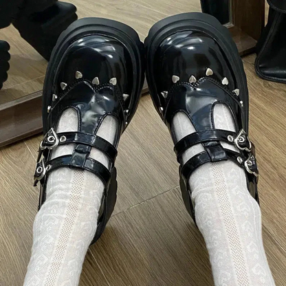 Front view of the black Mary Jane shoes with platform, showcasing delicate details of small metallic hearts around the shoe, adding a cute and sophisticated touch to the design
