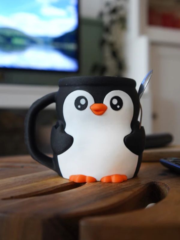 Penguin-shaped pint insulator for 16 oz ice cream containers.