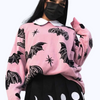 Pink Knit Sweater with Bats and Hearts, featuring a cute and spooky design for a perfect mix of kawaii and gothic style.