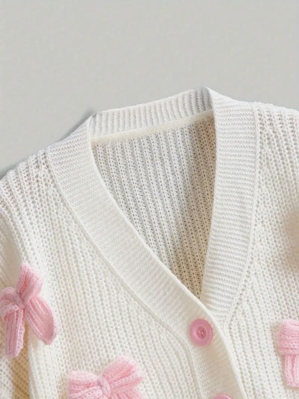Cute pastel pink cardigan for soft girl and kawaii style, cozy knit sweater with bow details, perfect for casual and romantic outfits.