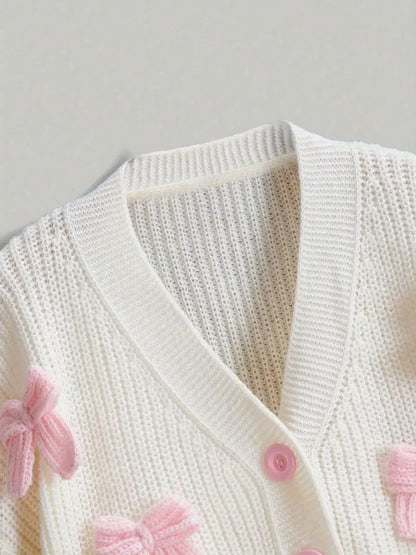 Cute pastel pink cardigan for soft girl and kawaii style, cozy knit sweater with bow details, perfect for casual and romantic outfits.
