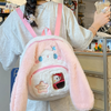 Pink backpack shown from the front, worn on the back of a model, featuring a transparent pocket where you can place a photo of your loved one or favorite character, adding a personal and unique touch to the design.