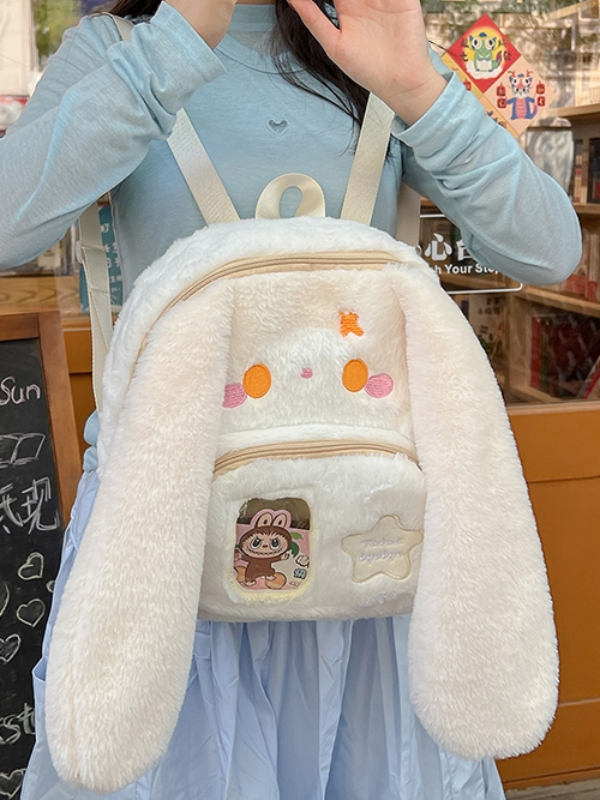Beige bunny plush bag with large orange eyes, in Japanese kawaii style, bringing a cute and charming touch to your look.