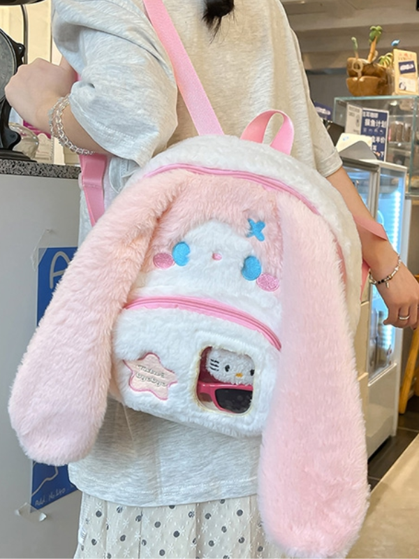 Pink bunny plush bag with large blue eyes, in Japanese kawaii style, adding a cute and charming touch to your look.