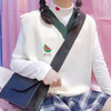 White sweater with a green collar and a cute watermelon embroidery, adding a fresh and playful touch.